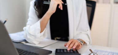 Businesswoman calculating expenses and managing budget in&nbsp;office